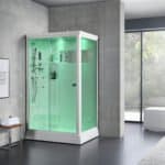 Cabina doccia con led verde in ambiente moderno, accanto a una stanza con vasca da bagno e grandi vetrate.