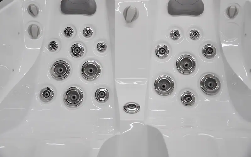 Vasca idromassaggio con numerosi ugelli e luci LED, bianca, dettagli di alta qualità Vasca idromassaggio bianca con numerosi ugelli e luci LED, perfetta per relax e benessere, dimensioni visibili, ambientata in un contesto spa domestica.